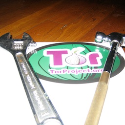 A picture of a Tor sticker with a hammer and wrench.
